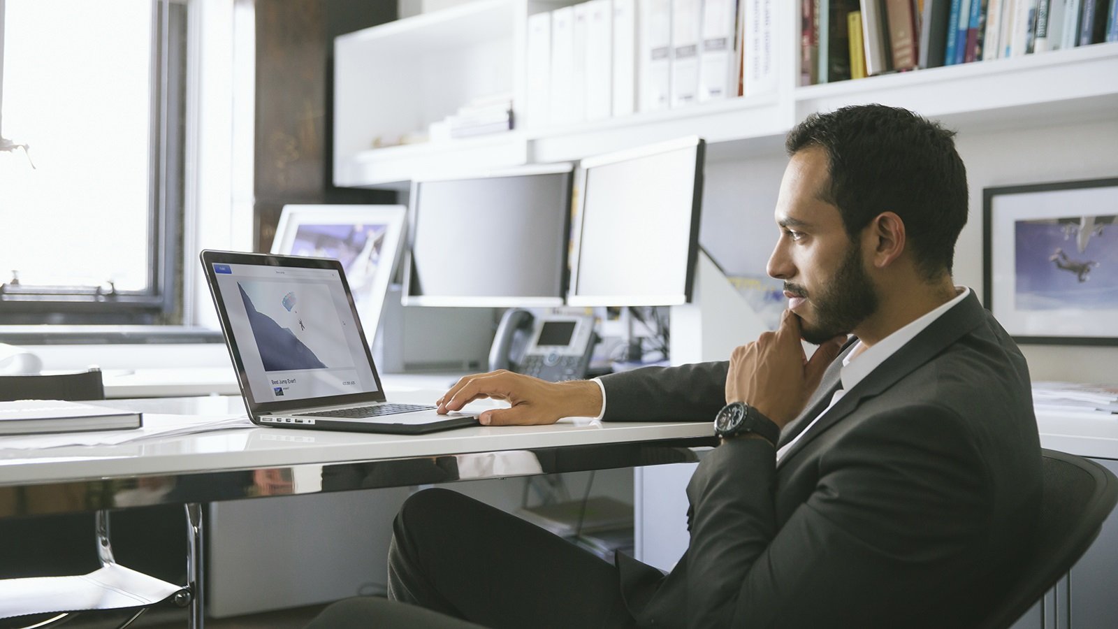 Man at desk using laptop.