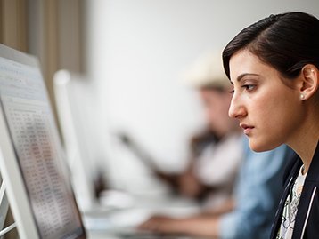 Woman looking at computer monitor. Woman looking at computer monitor.