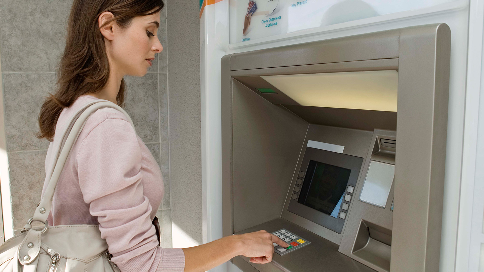 Woman standing at ATM. Woman standing at ATM.