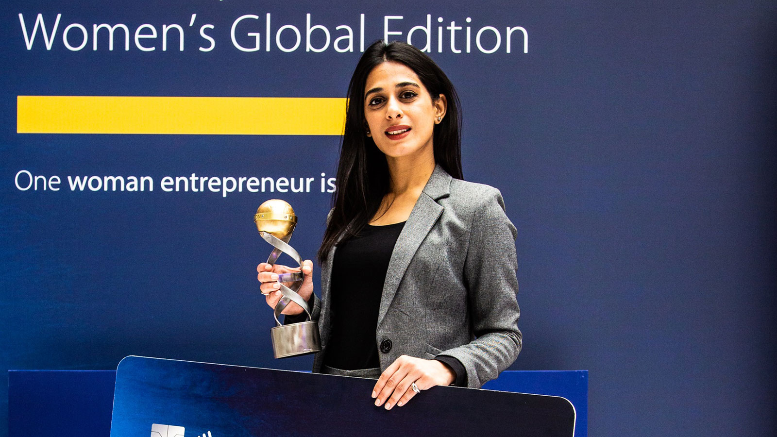 Naureen Hyat, winner of the Fintech challenge, posing with a trophy.