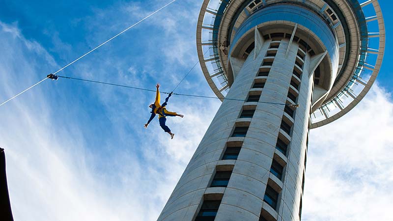 Photo of a person bungee jumping off of a tower while their holiday is paid using a credit card in New Zealand