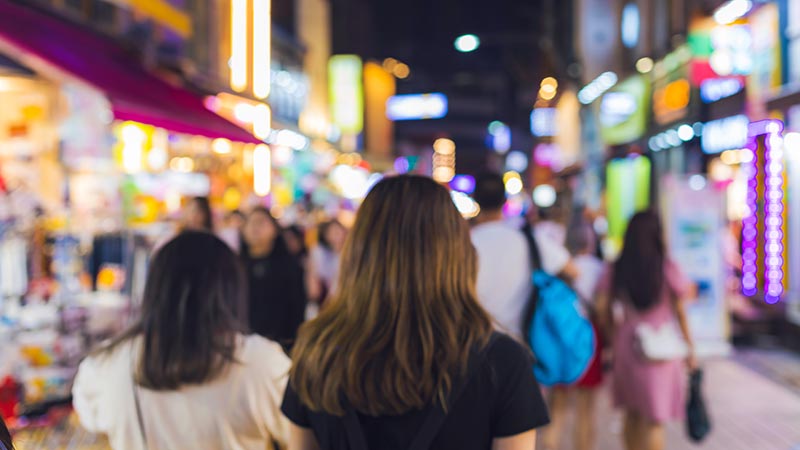 Photograph of people walking down a busy street as they paid for travel to Korea using Visa Korean debit card.